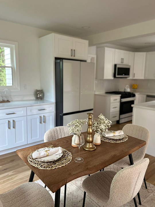 Renovated kitchen with updated cabinets, countertops, and dining space