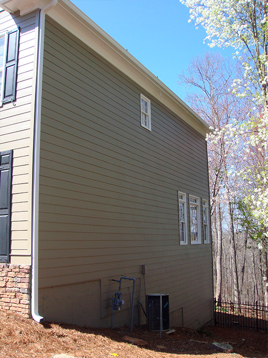 Gray vinyl siding installed on residential home exterior in Massachusetts