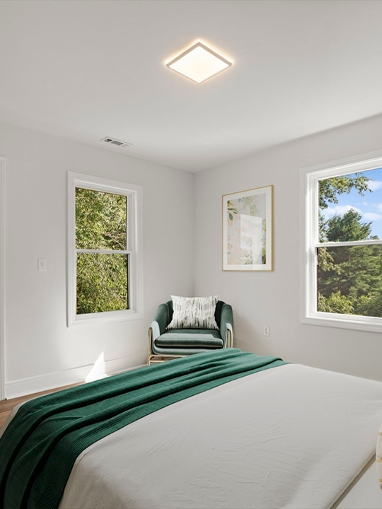 Updated bedroom in renovated flip property with fresh paint and new flooring