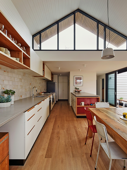 Home addition creating an expanded kitchen with vaulted ceilings and modern finishes